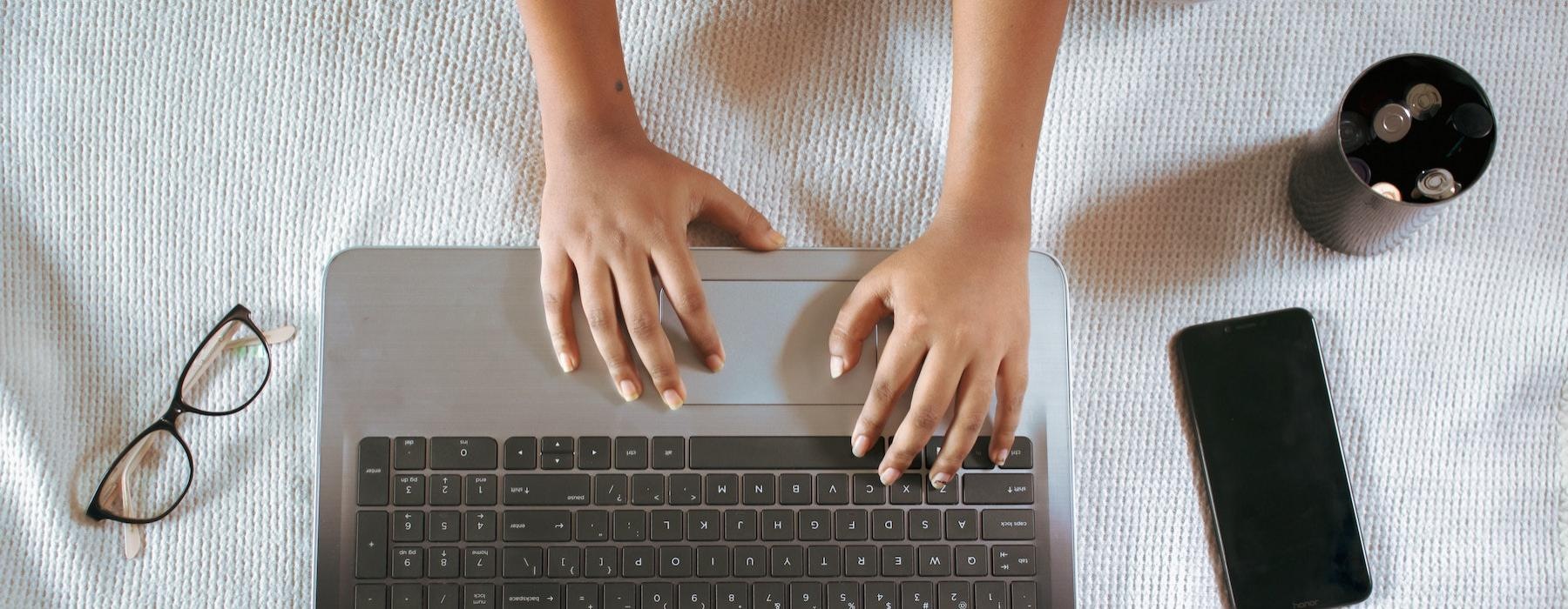 a person typing on a laptop
