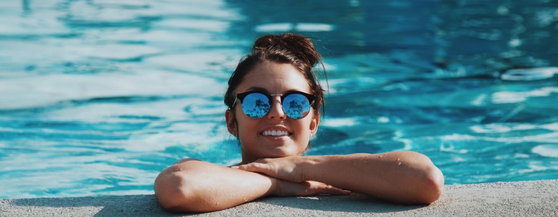 woman wearing sunglasses in a swimming pool