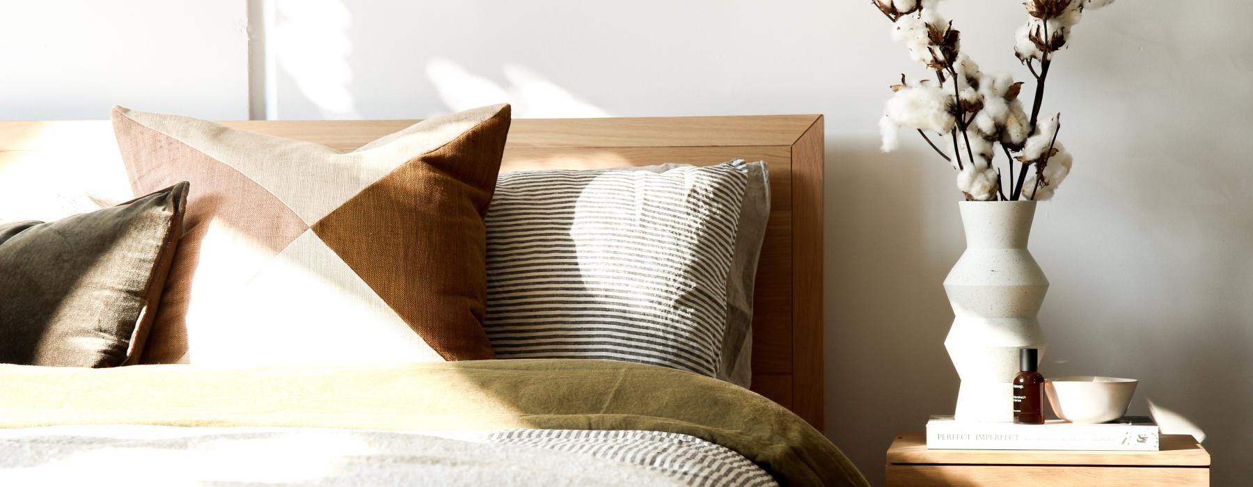 swath of sunshine falls across bed and side table