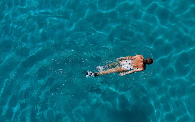 over head shot of woman swimming in a pool