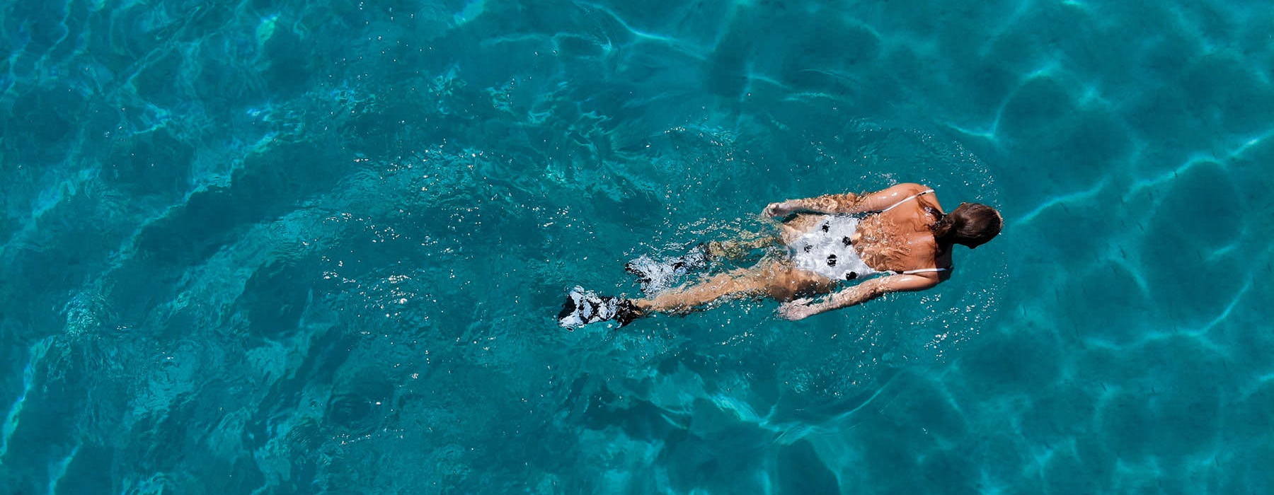 over head shot of woman swimming in a pool